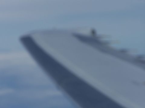 1979 Ford F-150 - View from an airplane window shows the wing against the sky.