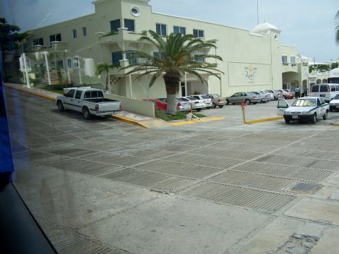 1979 Ford F-150 - A white pickup truck is seen parked on a sloped concrete area in front of a building.