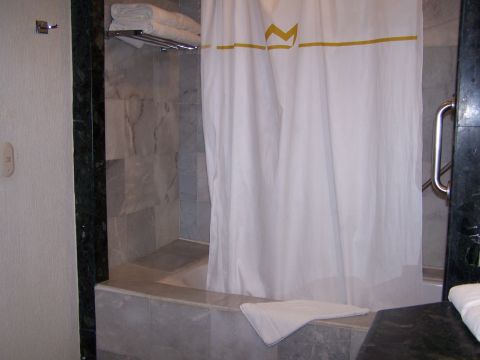 1979 Ford F-150 - A bathroom scene shows a bathtub with a shower curtain and towels on a rack.