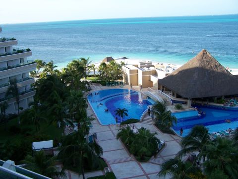 1979 Ford F-150 - A tropical resort features multiple swimming pools and a beach area overlooking the ocean.