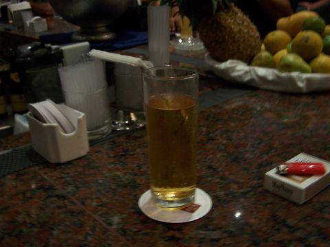 1979 Ford F-150 - A close-up view of a bar counter displays a drink, cigarettes, and a lighter, with fruit in the background.