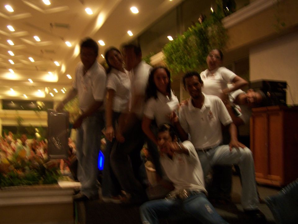 Group of people posing for a photo indoors with blurred background