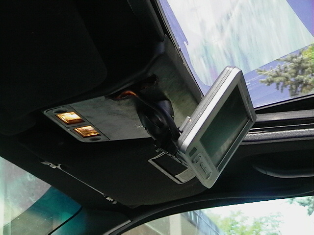 Overhead console and flip-out navigation or display screen near windshield