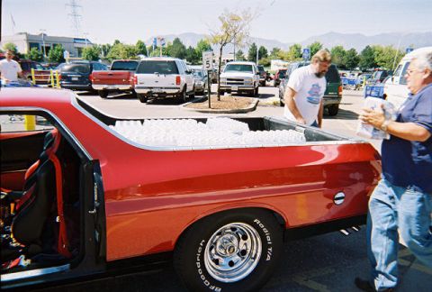 1972 Ford Ranchero - Red 1972 Ford Ranchero parked in a lot with its bed loaded with white items.