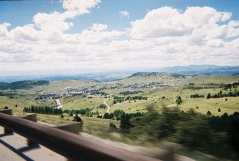 1972 Ford Ranchero - A scenic view of a town in a valley, surrounded by rolling hills under a cloudy sky.