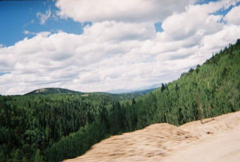 1972 Ford Ranchero - A scenic view of rolling hills covered in trees, with a dramatic sky overhead.