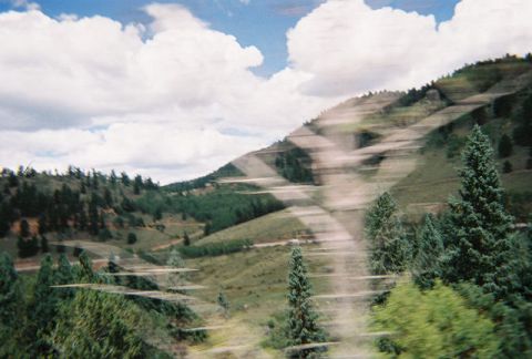 1972 Ford Ranchero - Mountain landscape with trees and clouds, motion blur effect.