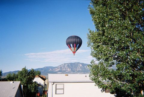 1972 Ford Ranchero - Hot air balloon ascends over a mountain range with houses in the foreground.