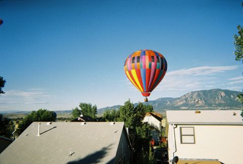 1972 Ford Ranchero - A hot air balloon with a vibrant patchwork design floats against a clear blue sky, with mountains in the background.