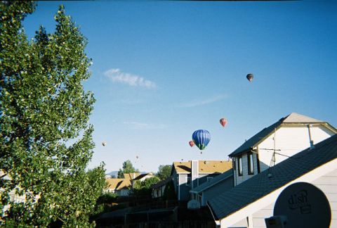 1972 Ford Ranchero - Hot air balloons ascend over a residential neighborhood on a clear day.