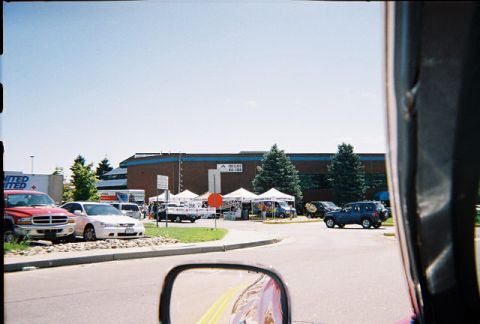 1972 Ford Ranchero - A scene in a parking lot with tents and various vehicles under a clear blue sky.