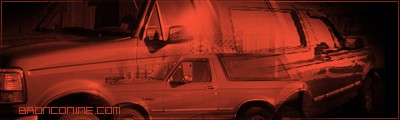 1995 Ford Bronco - Side profile of a 1995 Ford Bronco, captured with a red filter and website text.