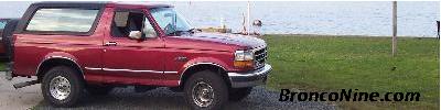 1995 Ford Bronco - This 1995 Ford Bronco is seen parked near the water with a black removable top.