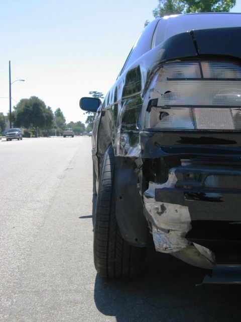 1985 Ford Bronco - Car sustained significant rear-end damage, affecting the quarter panel and tail light.