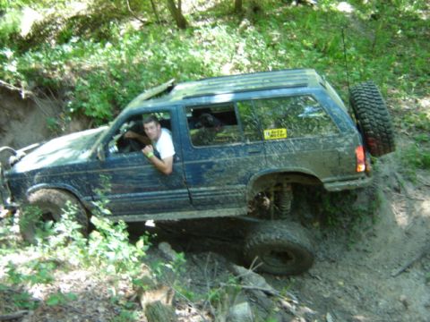 1992 Ford Bronco - This 1992 Ford Bronco is tackling a challenging off-road course in a wooded environment.