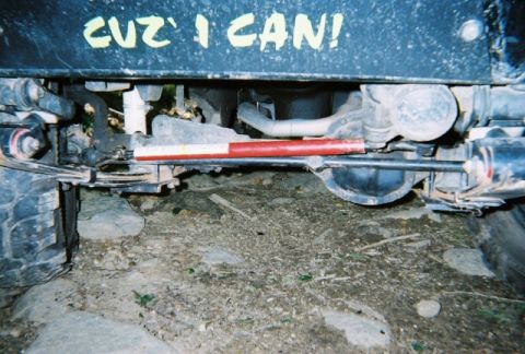 1976 GMC C/K Pickup - Close-up of off-road vehicle's undercarriage with custom text visible on the frame.