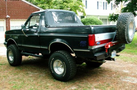1988 Ford Bronco - This 1988 Ford Bronco features a soft top and a spare tire mounted on the rear bumper.