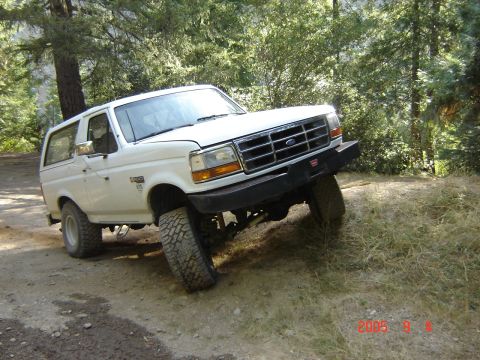 1993 Ford Bronco - This 1993 Ford Bronco navigates a challenging off-road trail, its capabilities on uneven terrain.