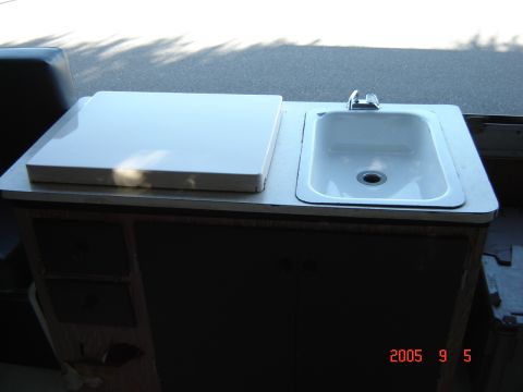 1993 Ford Bronco - Interior view of a sink and countertop assembly within a cabinet.