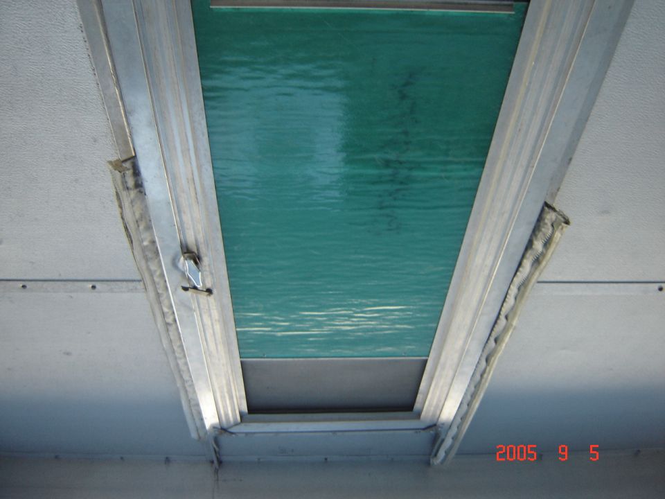 Interior view of a pop-up tent trailer window with green textured material