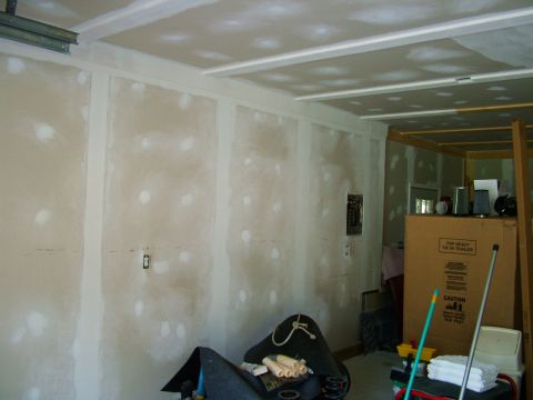2003 Ford Mustang - The image shows an unfinished room with drywall and various construction items, not a vehicle.