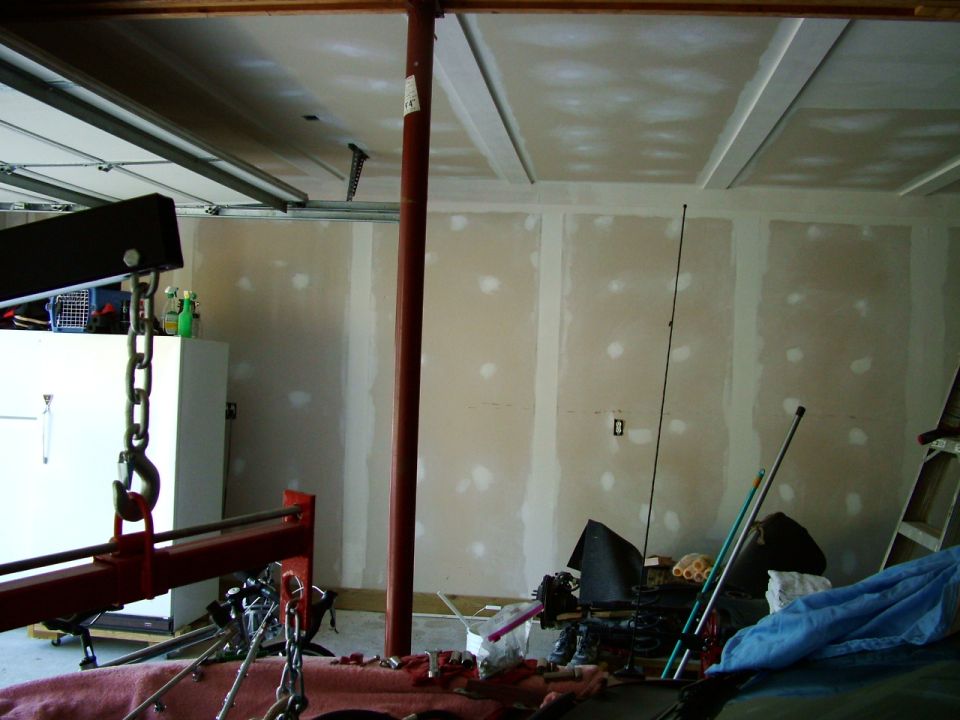 Garage scene with engine hoist and unfinished walls
