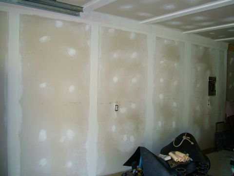 2003 Ford Mustang - Unfinished room interior with drywall and visible electrical components, including a Supermotors.net watermark.