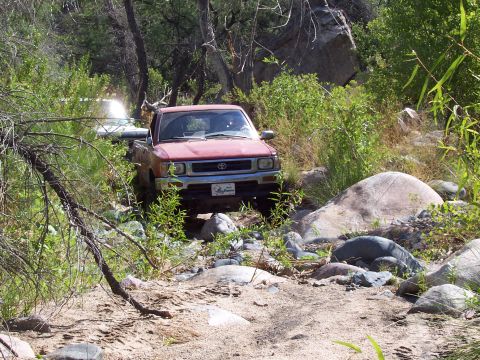 1981 Ford F-150 - Remember the skid plate dent? Took him a few tries, but he finally throttled over it. I put my drivers side on the big rock, and pass tire…