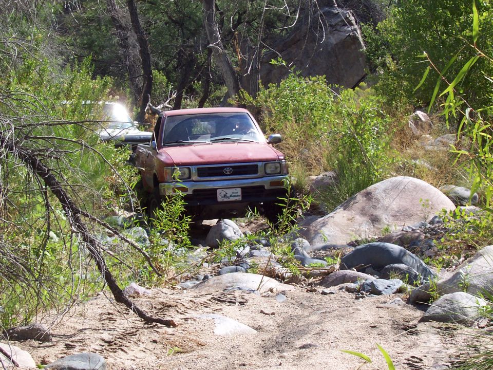 Remember the skid plate dent?  Took him a few tries, but he finally throttled over it.  I put my drivers side on the big rock, and pass tire on the smaller one.  Worked out well