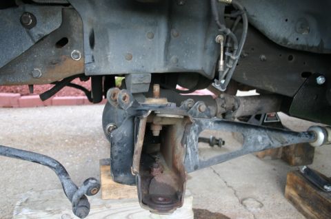 1994 Ford Bronco - Close-up view of vehicle suspension parts, showing a lift kit installation.