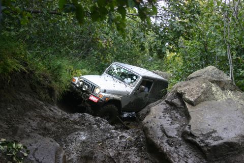 2003 Jeep TJ - A 2003 Jeep TJ tackles a challenging muddy and rocky off-road course.