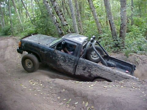 1992 Ford Ranger - This truck is navigating a challenging off-road course, getting stuck in a dirt pit.