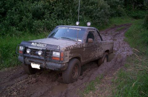 1992 Ford Ranger - This 1992 Ford Ranger is covered in mud as it navigates a challenging off-road trail.