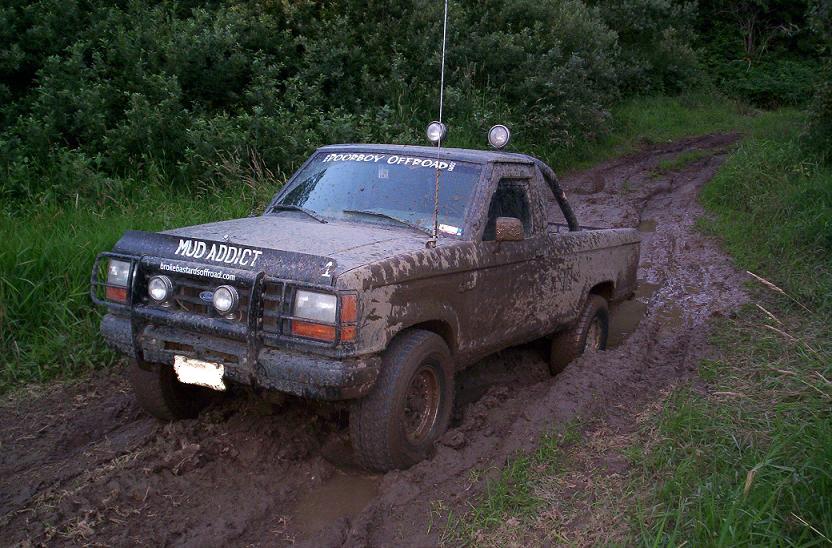 Mud-covered 1992 Ford Ranger driving through a muddy trail