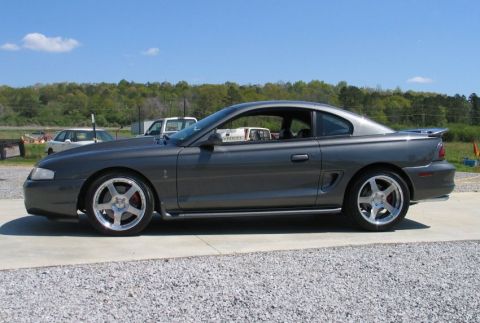 1995 Ford Mustang - This 1995 Ford Mustang coupe is shown from the side, a spoiler and aftermarket wheels.