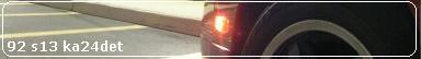 1992 Nissan 240SX - Close-up of a 1992 Nissan 240SX's rear wheel and illuminated turn signal.