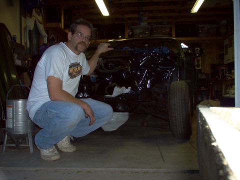 1970 Ford Ranchero - A man poses with a 1970 Ford Ranchero in a garage, possibly undergoing restoration.