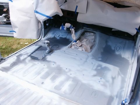 1982 Ford Bronco - The interior of a vehicle is being prepared for a spray-in liner application, with protective coverings in place.