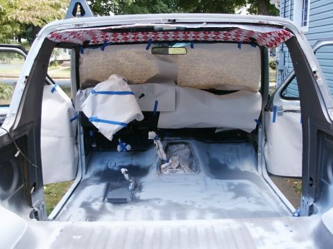 1982 Ford Bronco - The interior of a vehicle is prepped for a spray-in liner, with surfaces masked and ready for coating.