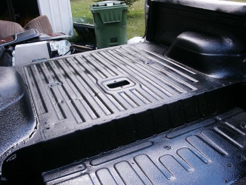 1982 Ford Bronco - Newly applied spray-in liner in a truck bed, showing the ribbed floor texture.
