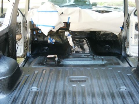 1982 Ford Bronco - Interior of a vehicle undergoing application of spray-in bed liner material.