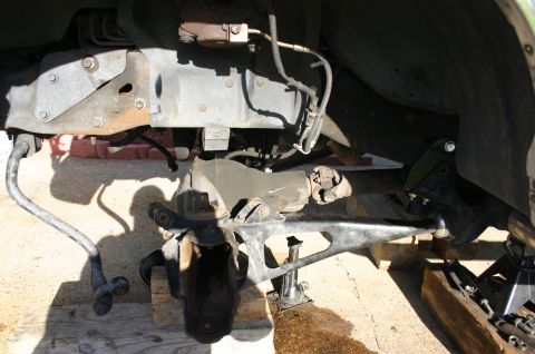 1994 Ford Bronco - Close-up of a vehicle's front suspension system, indicating modifications for a lift kit.