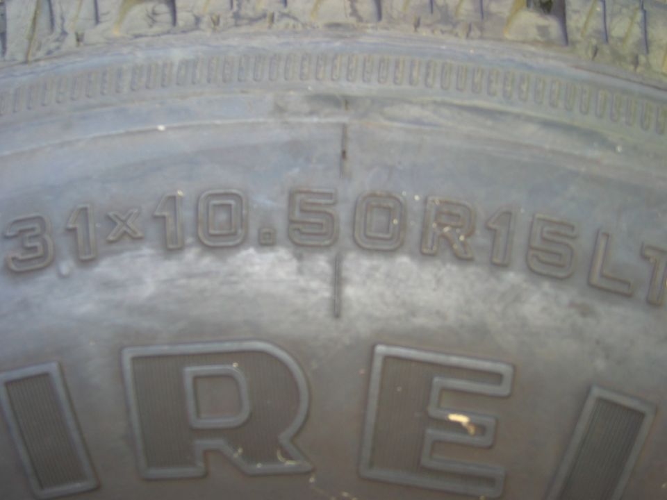 Tire sidewall stamped 31x10.50R15LT in raised lettering