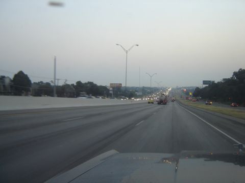 1988 Ford LTD Crown Victoria - View from a vehicle driving on a highway with traffic in the distance.
