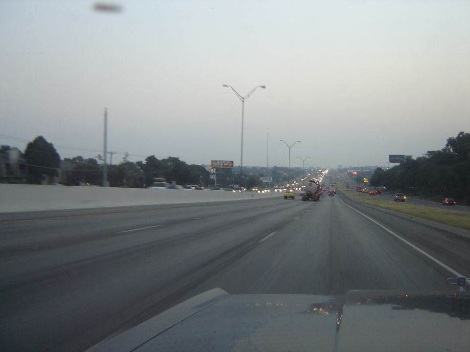 Highway traffic scene with cars and trucks on a multi-lane road
