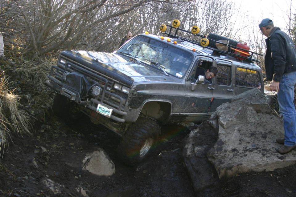 Black SUV navigating rocky terrain