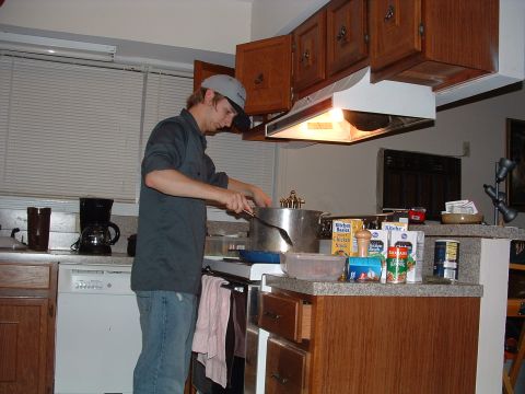 1993 Ford Bronco - A man is seen cooking in a kitchen environment, with various appliances and cabinetry in the background.