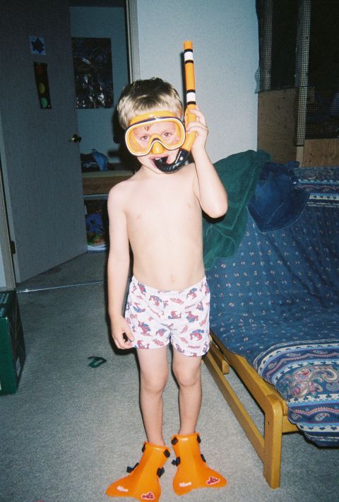 1990 Ford Bronco - A young child poses in a bedroom wearing a snorkel mask, snorkel, and flippers.