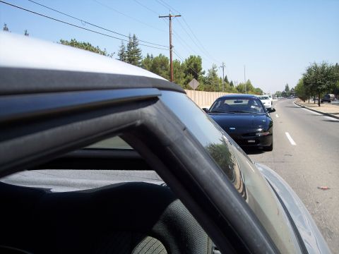 1993 Ford Probe - Driving behind a black 1993 Ford Probe on a clear day.