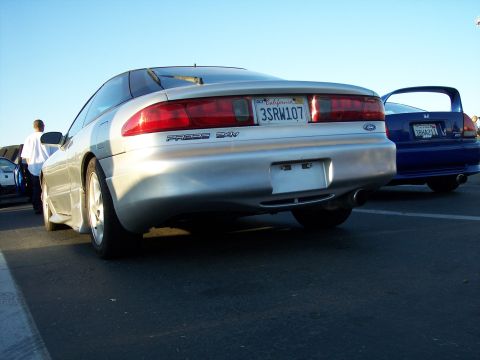 1993 Ford Probe - The rear of a silver 1993 Ford Probe is visible, parked next to a blue vehicle.